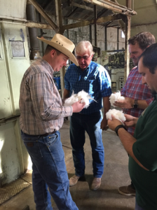 Gin Manager Stan Creelman discussing cotton quality with Assemblyman Mathis